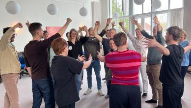 
		Trainees at the School of Participation stand together as a group
	